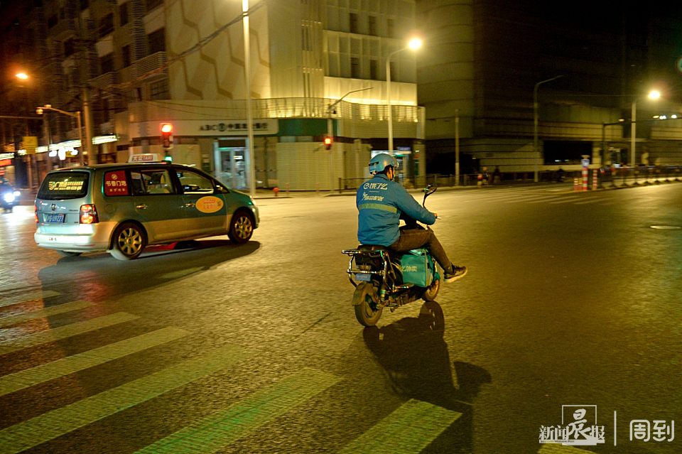 夜已深,街道十分安静,外卖小哥骑着电动车的身影仍在忙碌.